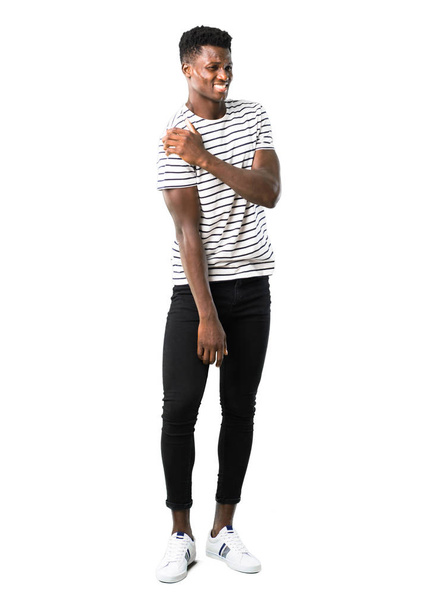Full body of Dark skinned man with striped shirt with shoulder pain on white background - Photo, image