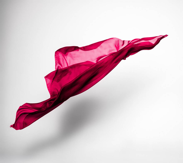 abstract piece of red fabric flying, high-speed studio shot - 写真・画像