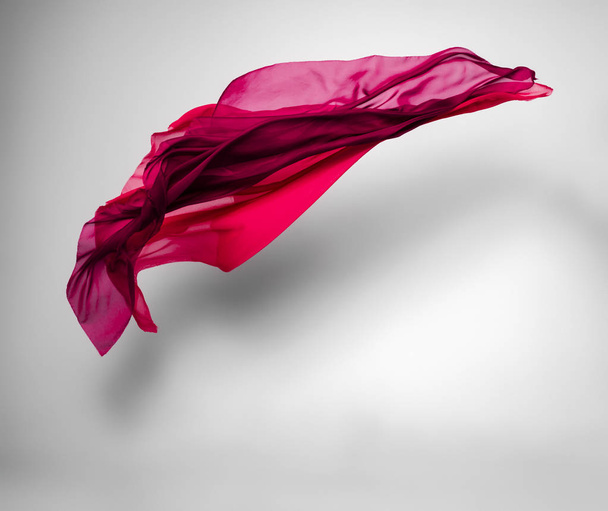 abstract piece of red fabric flying, high-speed studio shot - Foto, imagen