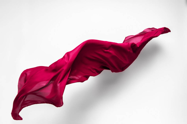 abstract piece of red fabric flying, high-speed studio shot - Zdjęcie, obraz