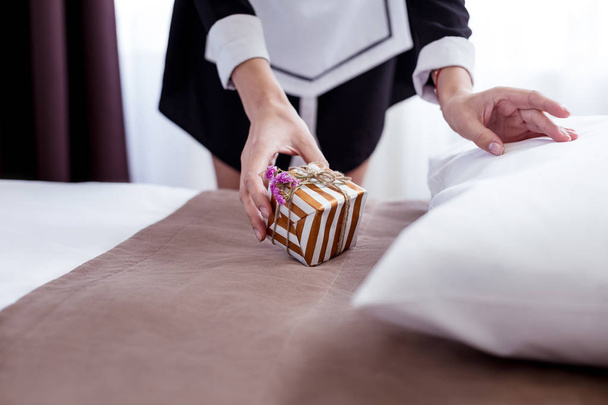 Close up of a small present being put on the bed - Foto, imagen