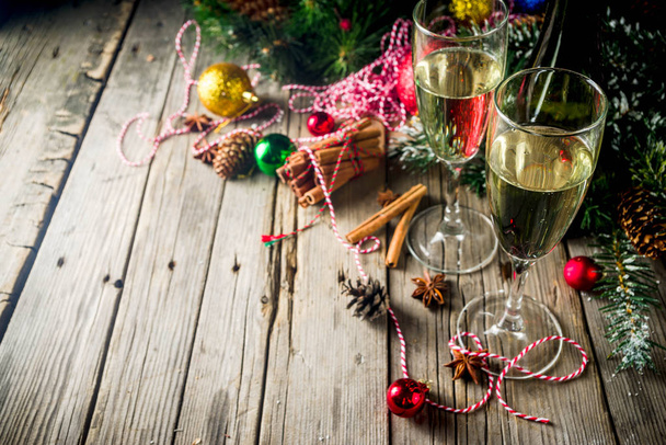 Twee glazen van champagne met Kerstdecoratie op houten achtergrond, Happy New Year en Xmas viering. Kopiëren van ruimte - Foto, afbeelding