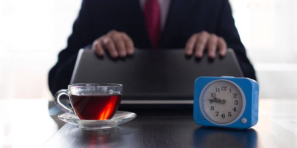 Businessman closes the laptop for a tea break. - Foto, imagen