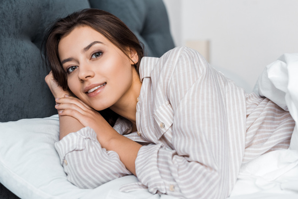 beautiful girl in pajamas relaxing in bed - Photo, Image