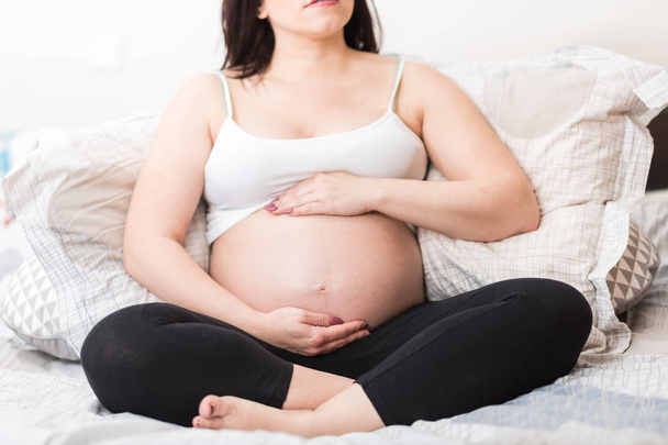 mulher grávida de mãos dadas na barriga - Foto, Imagem