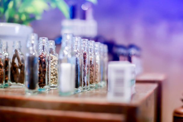 Ancient herb in glass jars on wooden table in Chinese or Thai herbal medicine shop. Vintage Asian objects. - Photo, Image