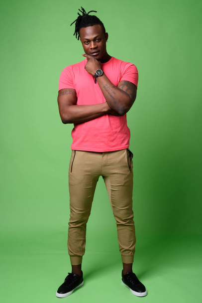Young handsome African man from Kenya against green background - Fotografie, Obrázek