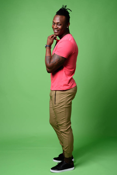 Young handsome African man from Kenya against green background - Photo, image