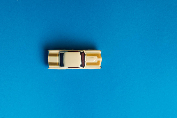 elevated view of toy car on blue background, minimalistic concept - Foto, Imagem