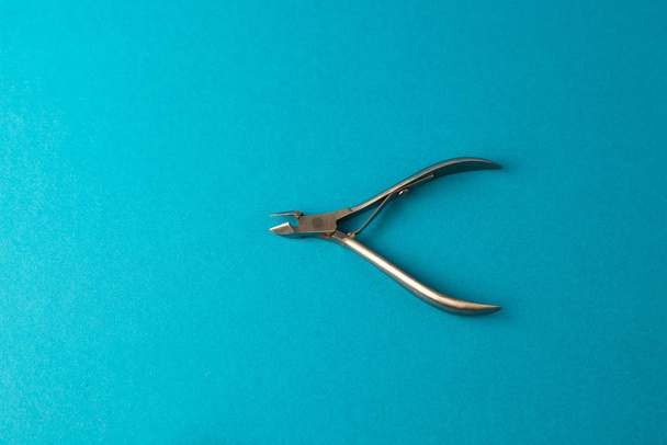 view from above of cuticle nippers for personal hygiene on blue background - Φωτογραφία, εικόνα
