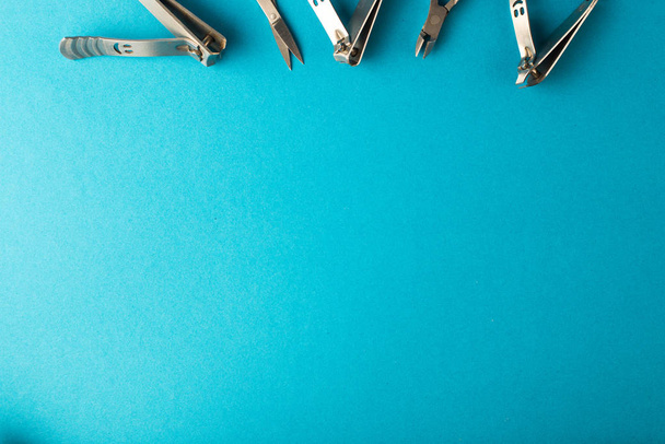 set of tools for manicure and nail care on a blue background. - Foto, afbeelding