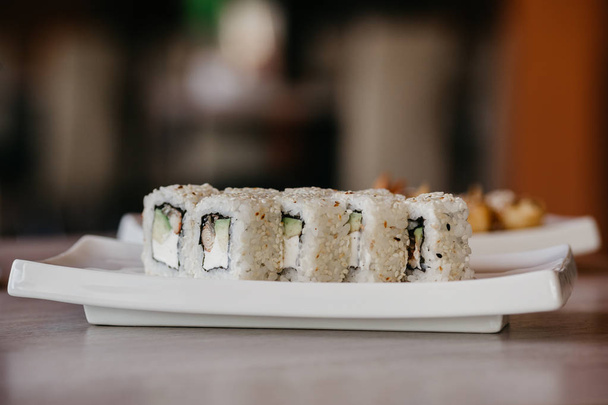 Philadelphia roll sushi with cucumber, cream cheese, red caviar. Sushi menu. - Photo, image
