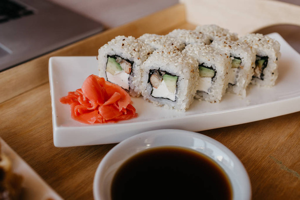 Philadelphia roll sushi with cucumber, cream cheese, red caviar. Sushi menu. - Foto, afbeelding