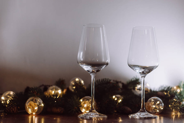 Christmas decoration with two glasses  and lights on a wooden background, Happy New Year.  - Foto, Imagem
