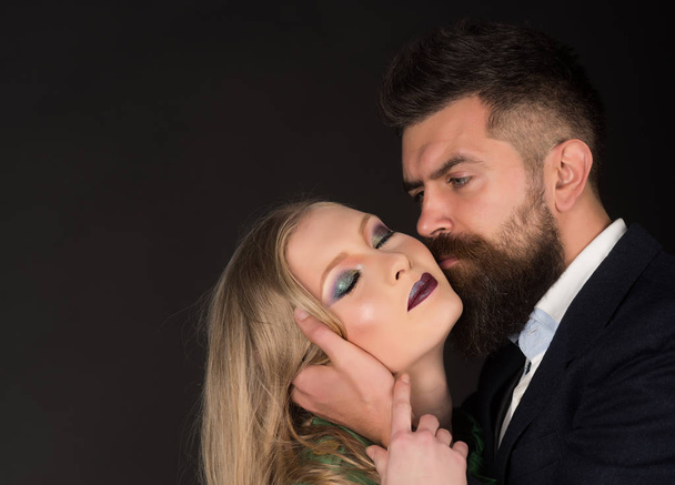 Sensual pleasures. Intimate couple in fashion clothing. Couple in love. Style icons. Bearded man hug woman with long hair. Fashion style and hair care. They both love fashion, copy space - Zdjęcie, obraz