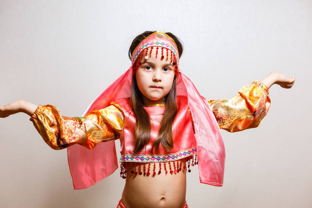 little brunette girl in eastern beauty costume on white background - Valokuva, kuva