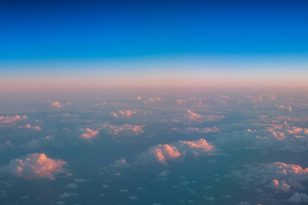 Летят над облаками. Вид с воздуха из окна самолета
 - Фото, изображение