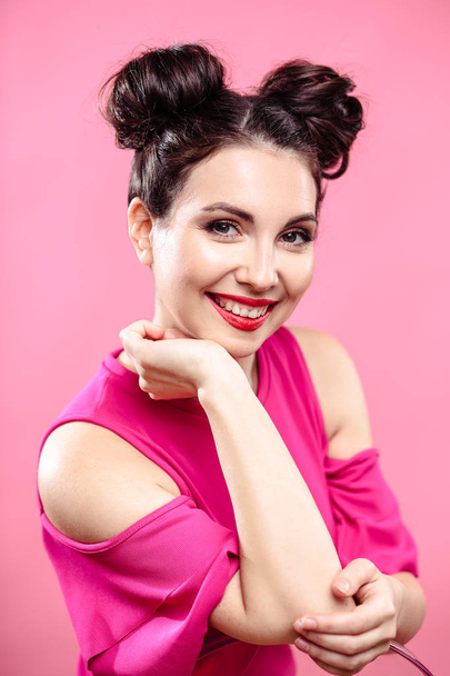 Beauty portrait of young brunette woman on a bright pink background. Model with make-up and hairstyle, closeup, fashion glamour photo - Φωτογραφία, εικόνα