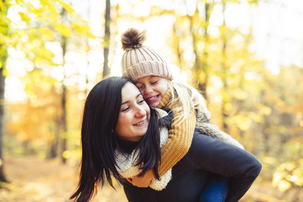 A Happy family on autumn, Mother and daughter in the Park - 写真・画像