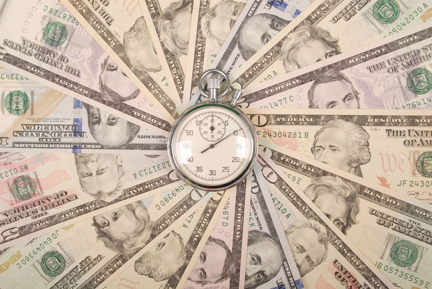 Stopwatch on mandala kaleidoscope from money. Abstract money background raster pattern repeat mandala circle. - Photo, Image