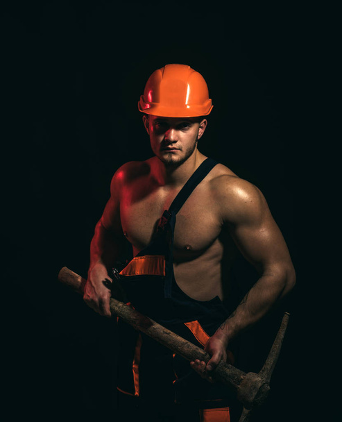 We renovating, under construction. Construction worker. Muscular man worker. Hard worker with muscular torso. Man miner with mining equipment. Mining area under construction - Fotoğraf, Görsel