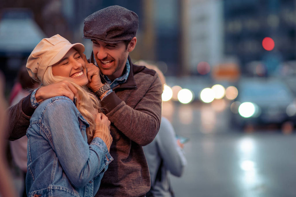 Porträt eines glücklichen jungen Paares, das eine Nacht in der Stadt genießt. - Foto, Bild