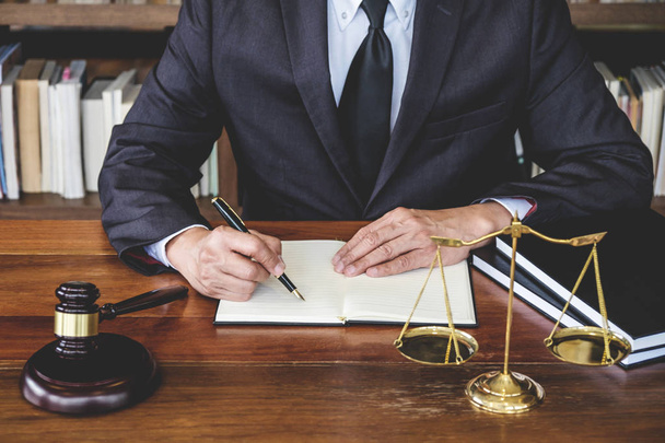 Legal law, advice and justice concept, Judge gavel with Justice lawyers, Counselor in suit or lawyer working on a documents in courtroom. - Photo, Image