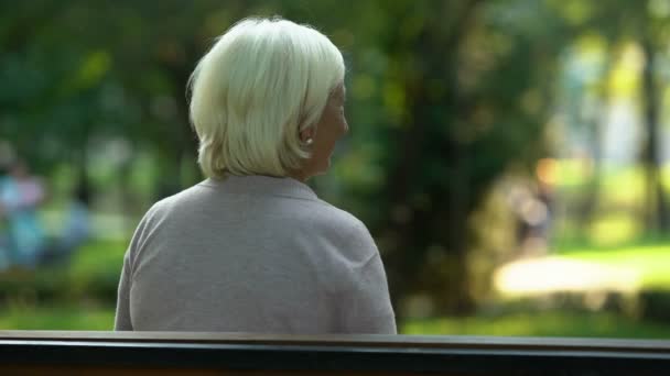 Girl hugs granny sitting on bench, sincere love for relatives trusting relations - Filmagem, Vídeo