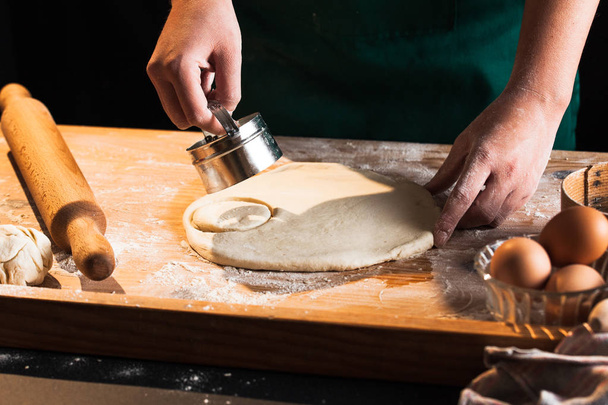 Hands of a chef baker woman kneading dough - Fotoğraf, Görsel
