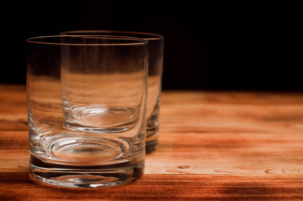 Glasses for whiskey on a wooden table - Fotó, kép