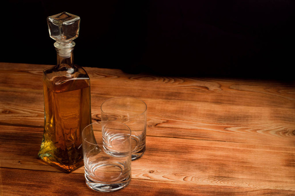 Glasses for whiskey on a wooden table - Fotoğraf, Görsel