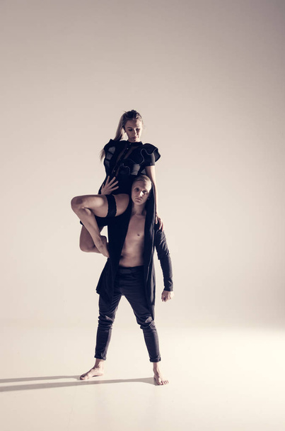 young acrobat sensual dancers on empty background  - Fotó, kép