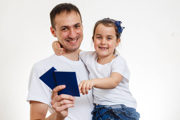 Smiling father with passports and daughter isolated on white background  - Photo, Image