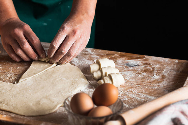 Hands of a chef baker woman kneading dough - Fotó, kép