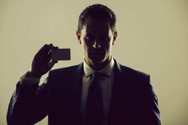 shadow business, businessman holding bank or business card - Valokuva, kuva