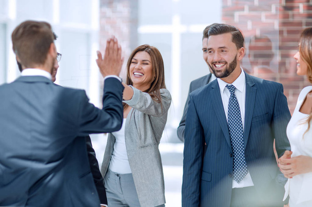 smiling business colleagues give each other a high five.the concept of teamwork - Fotó, kép