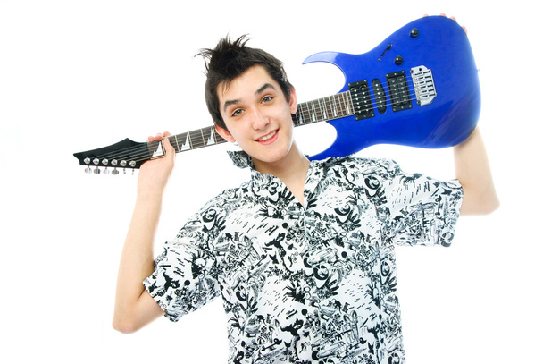 Handsome teenage boy with a guitar - Foto, Bild