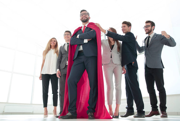 boss is a superhero and the business team is standing together - Foto, afbeelding