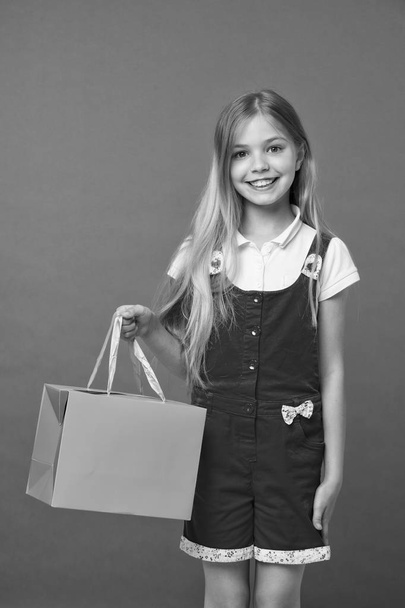 Summer sale. Girl cute teenager carries shopping bag. Kid bought clothing summer sale. Sale benefits. Seasonal sale concept. Girls absolutely fond of shopping. Simple reminders how to shop smart - Φωτογραφία, εικόνα