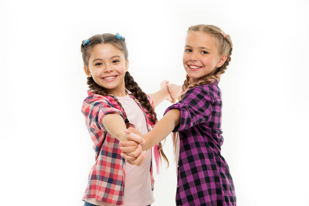 Dress similar with best friend. Dress to match your friend. Best friend dressing. Girls friends wear similar outfits have same hairstyle kanekalon braids white background. Sisters family look outfit - Photo, Image