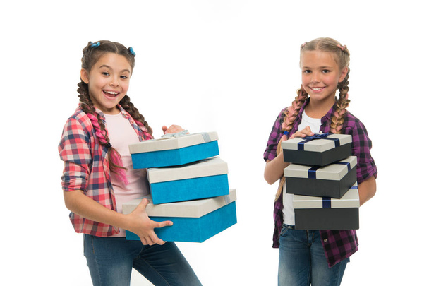 Kids little girls with braids hairstyle hold piles gift boxes. Children excited about unpacking gifts. Small girls sisters received birthday gifts. Dreams come true. Best birthday and christmas gifts - Фото, зображення
