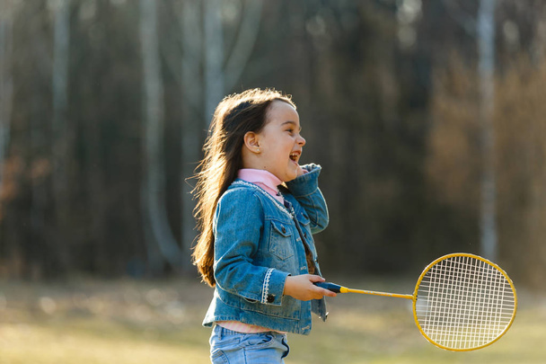Little girl playing badminton in park - Photo, Image