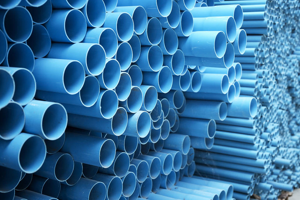 background of colorful  Blue PVC pipes stacked in construction site - Photo, Image