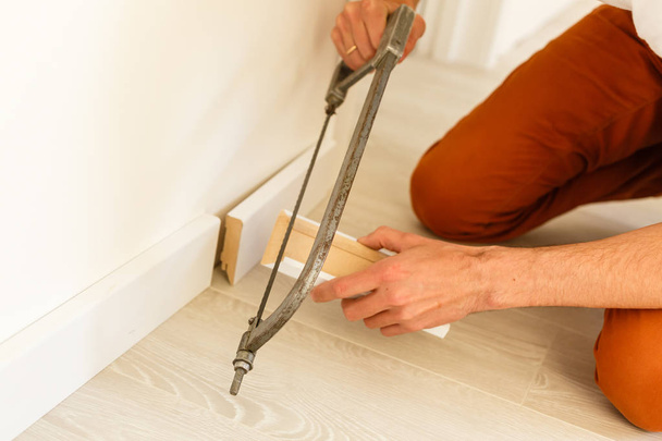 Close view of man installing new skirting board  - Photo, Image