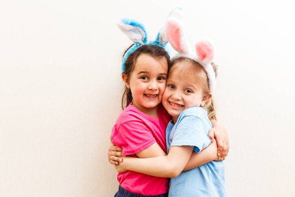 Two little girls with bunny ears isolated on white background - Φωτογραφία, εικόνα