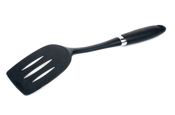 Fekete műanyag konyhai spatula elszigetelt fehér background, felülnézet - Fotó, kép