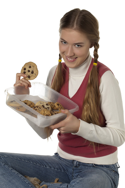 a teenage girl holding a tupperware of cookies - Foto, immagini