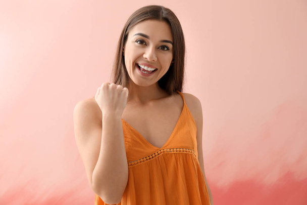 Happy young woman on color background - Photo, Image