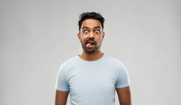 indian man making faces and showing his tongue - Photo, image