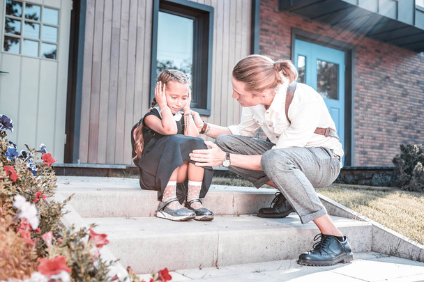 Caring father calming his little cute daughter feeling worried before school - Valokuva, kuva